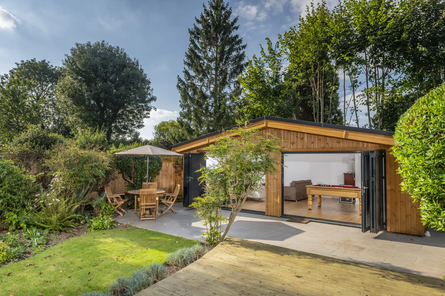 Contemporary garden room with bi-fold doors and pool table interior